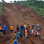 The death toll from the Indonesian landslide rises to 74, and the search faces difficulties